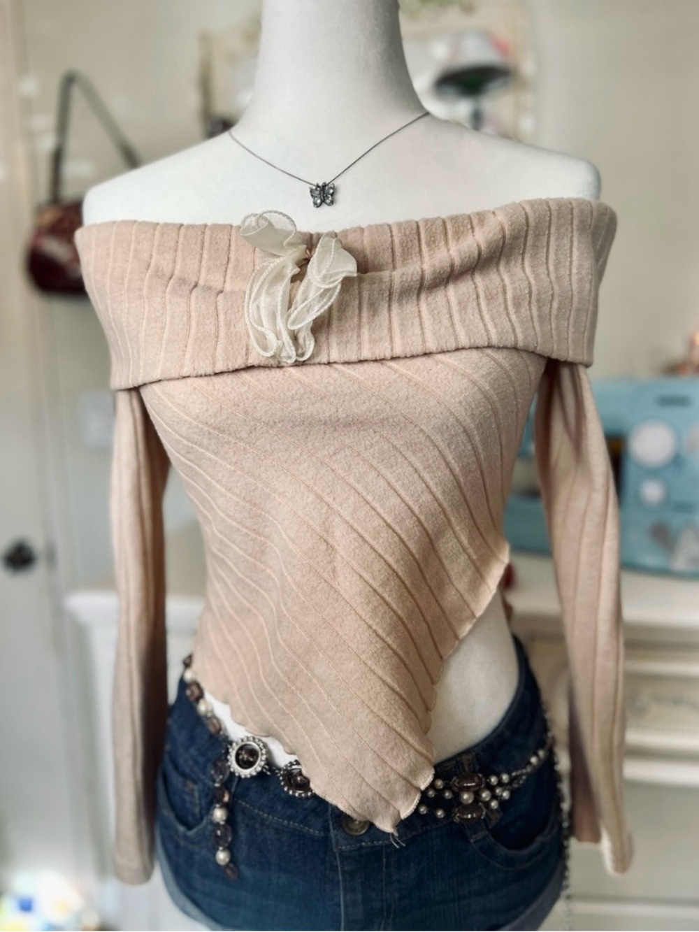 Off-Shoulder Pointed Hem Knit Sweater in creamy color